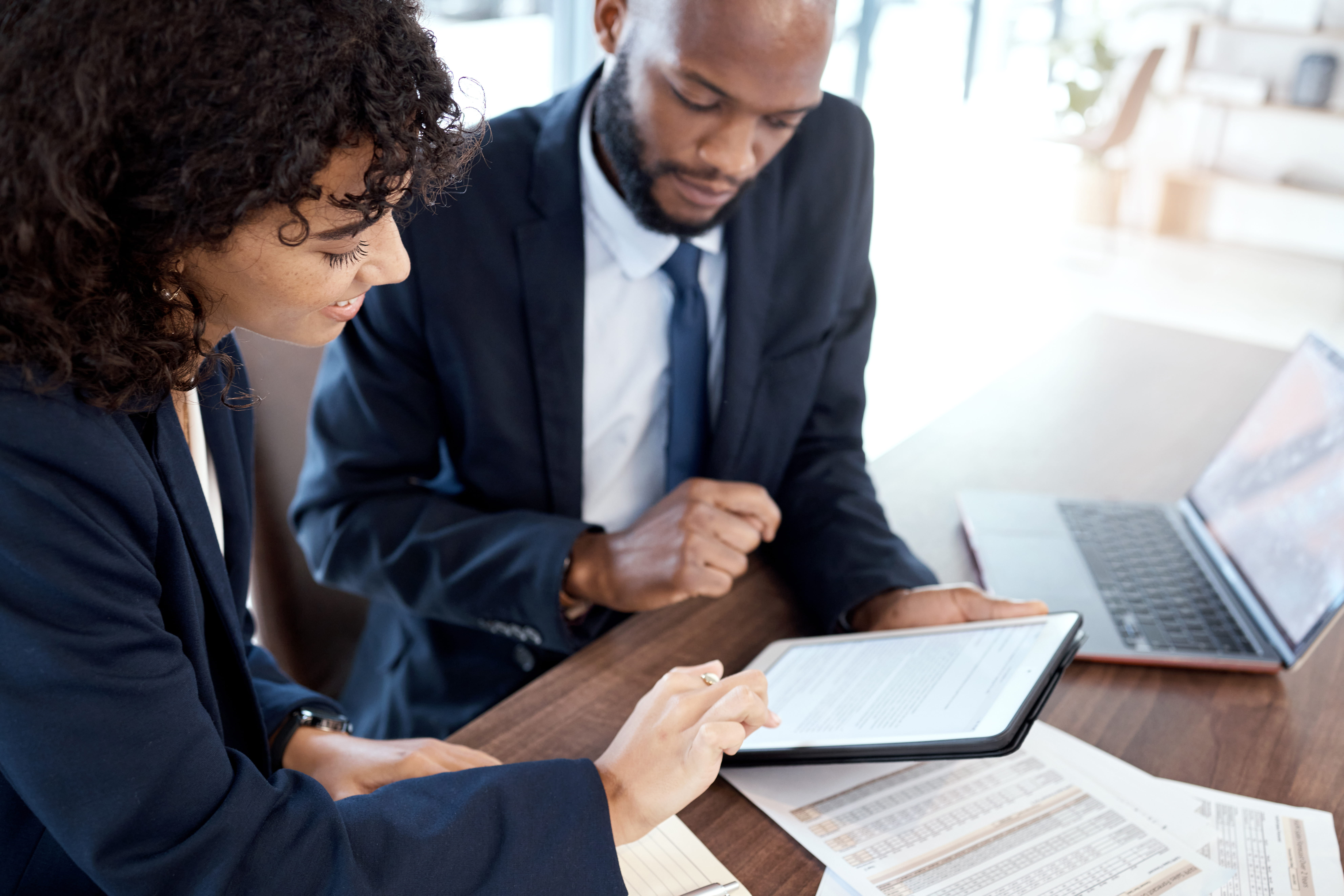 corporate-black-man-and-woman-with-tablet-docume-2026-01-09-10-07-29-utc (1)