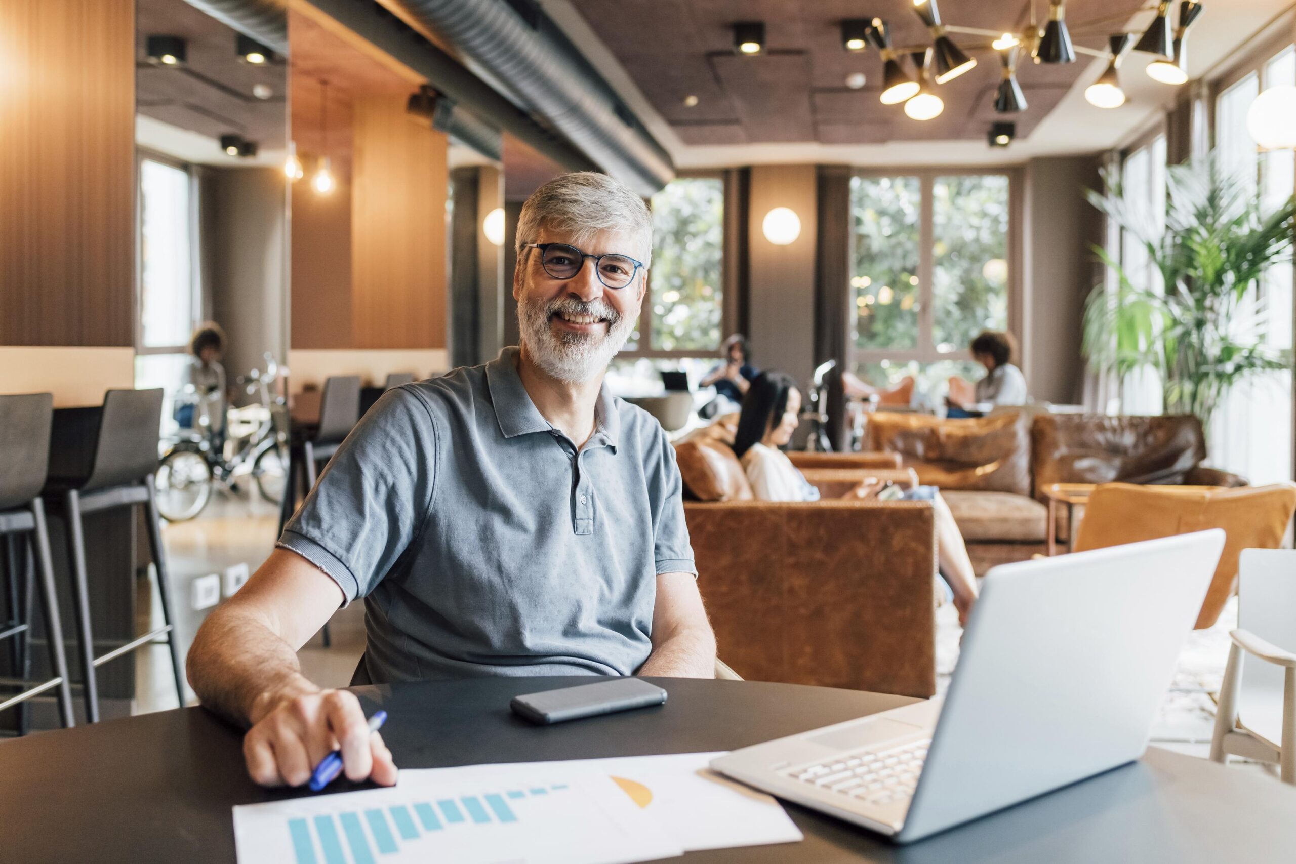 Portrait of smiling man working at table in creative studio