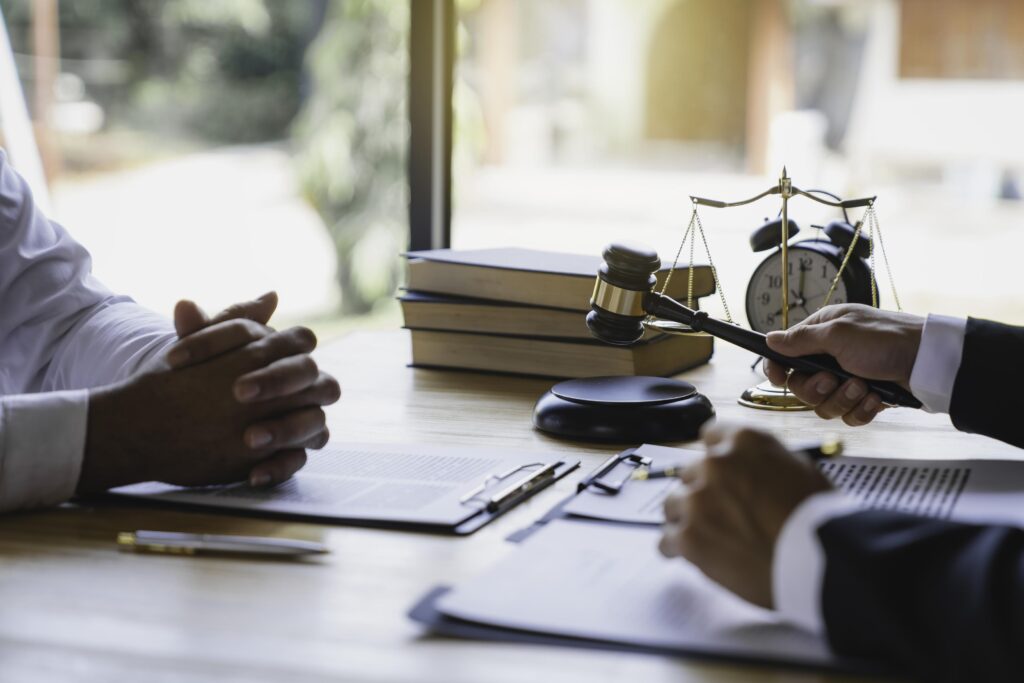 The lawyer working with a client discussing contract paper, a Business lawyer working about legal legislation in the courtroom to help their customer