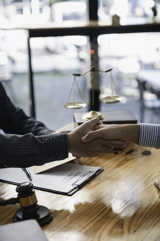 lawyer or judge shaking hands after agreeing to accept a bribe From businessman to lawsuit to win legal, illegal bribery, bribery and corruption concept.
