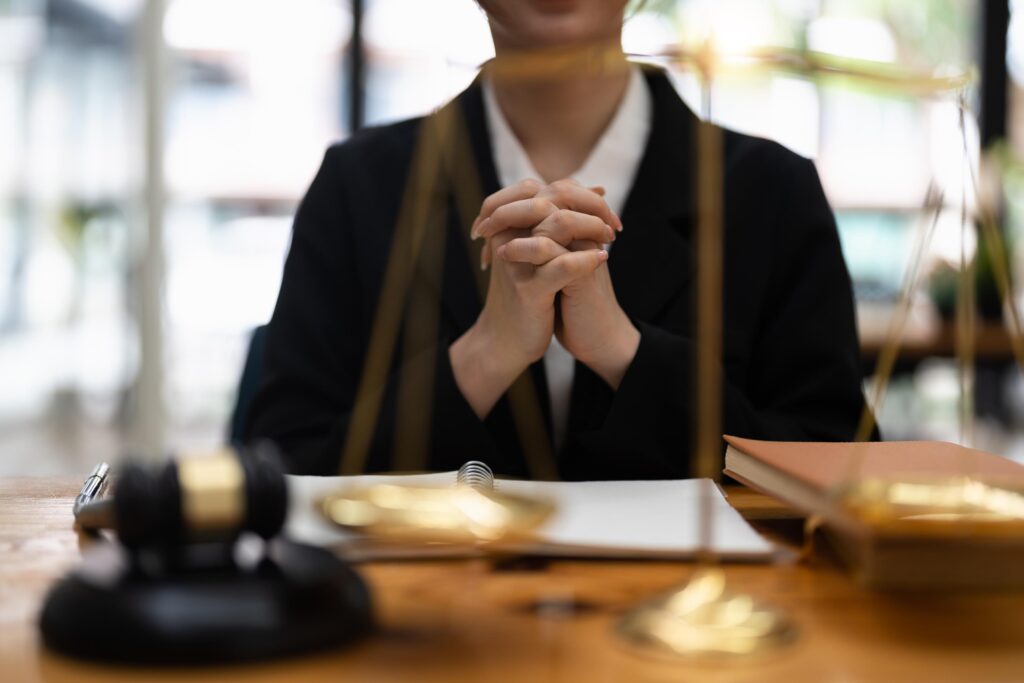 Legal Professional At Desk With Scale and Gavel
